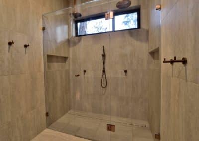 Custom frameless glass shower screen installed in a modern Eltham bathroom