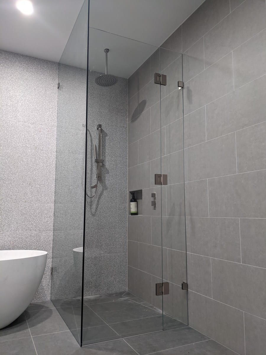 Floor to ceiling corner shower screen installation in Essendon
