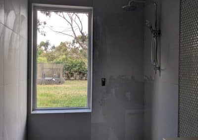 Full height frameless shower screen panel in Woodend