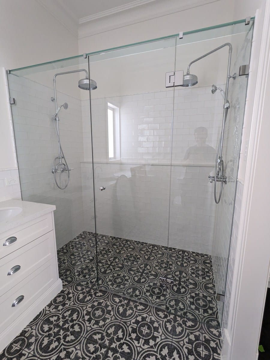 Wall to wall frameless shower screen with chrome hardware in Essendon