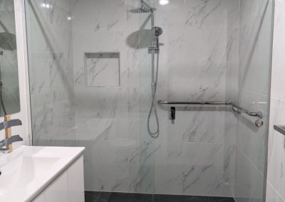 Frameless sliding shower screen with marble tiles Melbourne