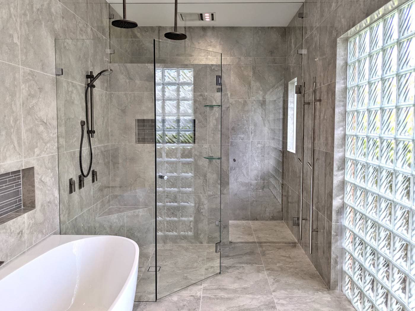 Custom frameless shower screen with return panel in contemporary bathroom