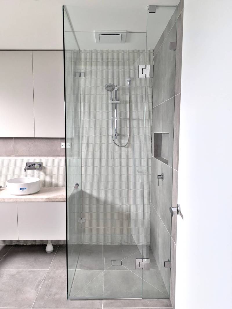 Full height glass shower screen with chrome fittings and wall hang vanity