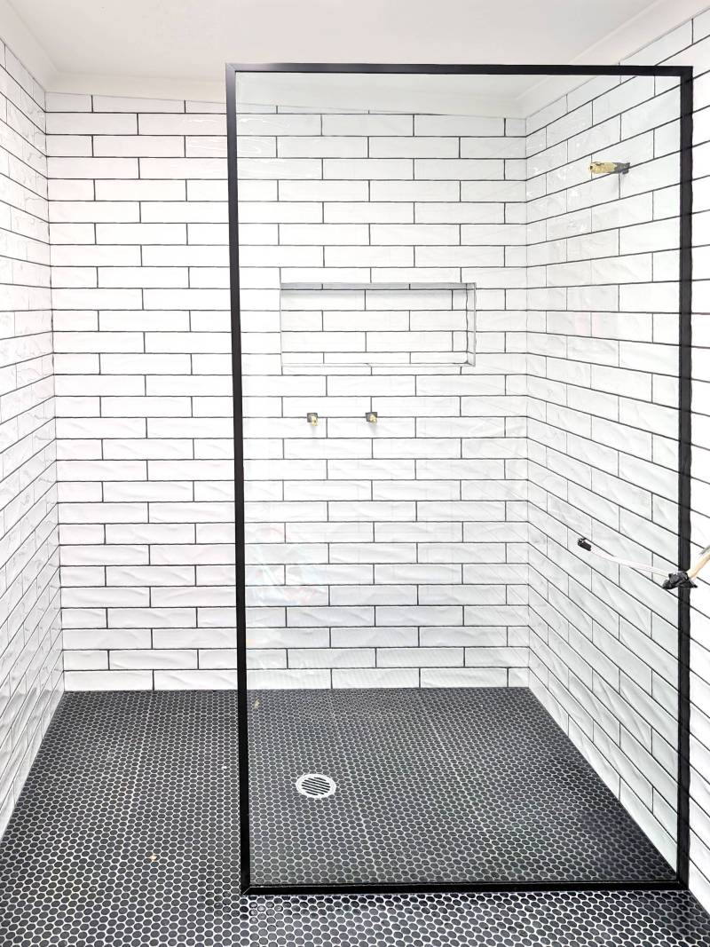 Black Frame Shower screen Walk in shower with a fully framed shower panel in black and subway tiles