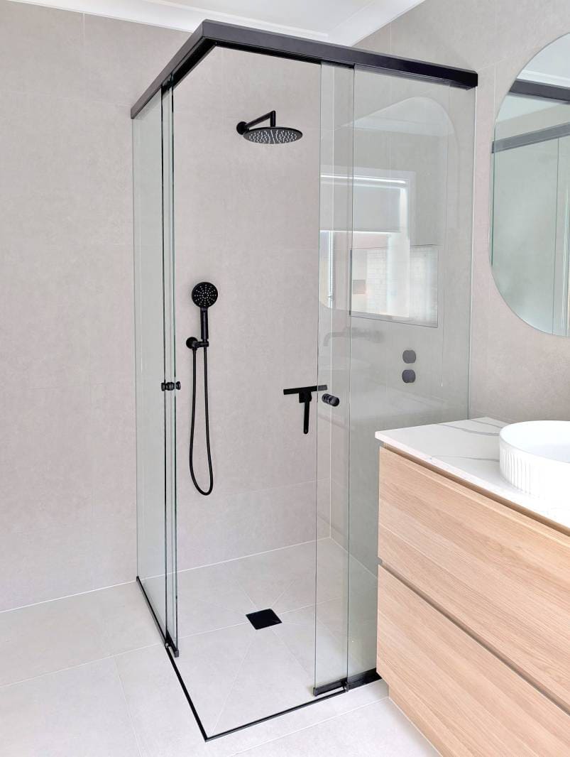 Corner-entry sliding door shower screen and timber look vanity