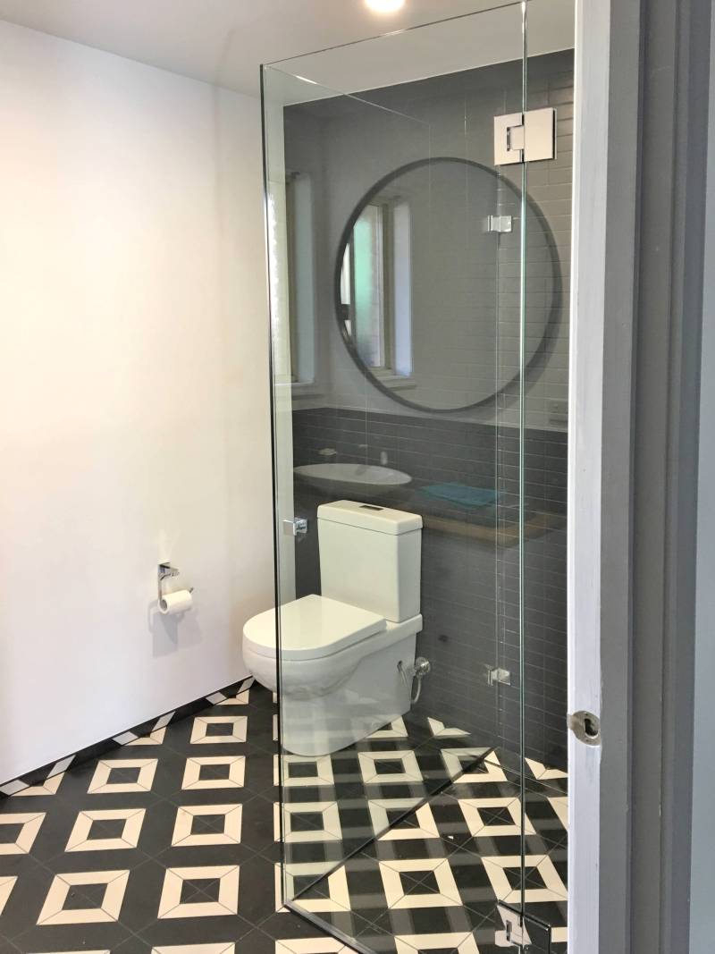 Small bathroom with toilet and frameless shower screen