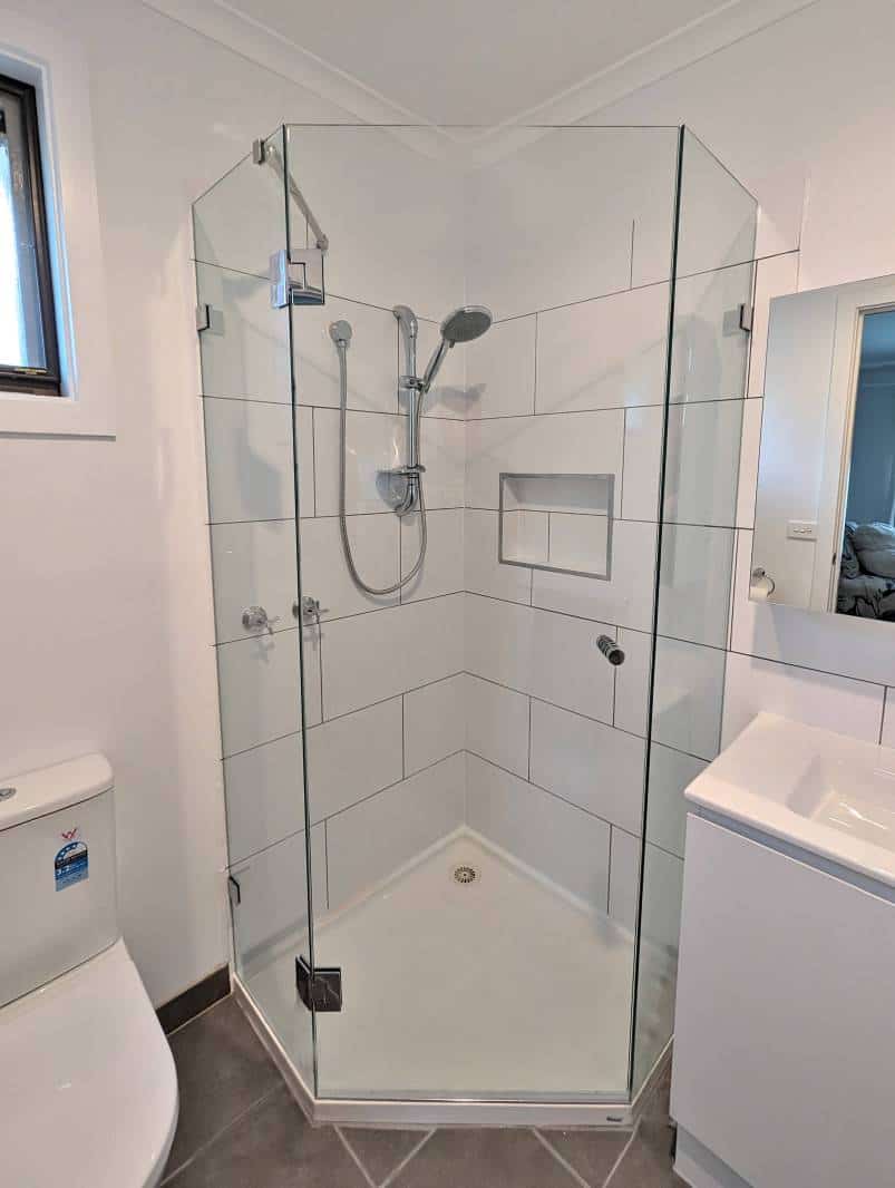Diamond shape shower screen on white base in a small ensuite