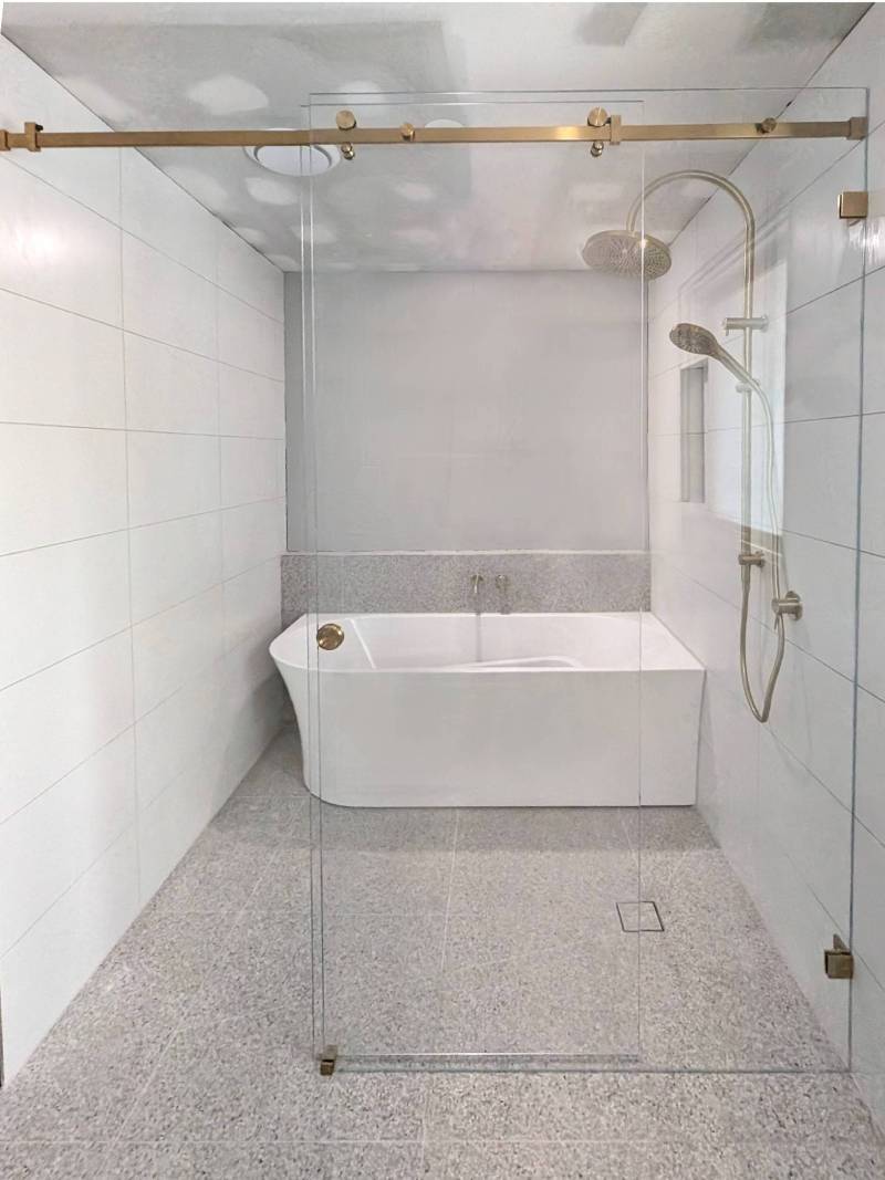 brushed-gold-sliding-shower-screen-bathroom Full width sliding shower screen with brushed gold hardware