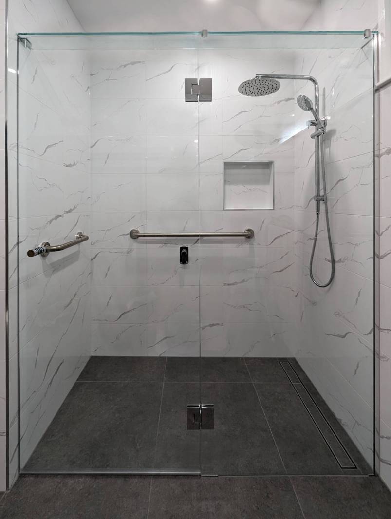 Full width frameless shower screen with wide door for wheel chair access