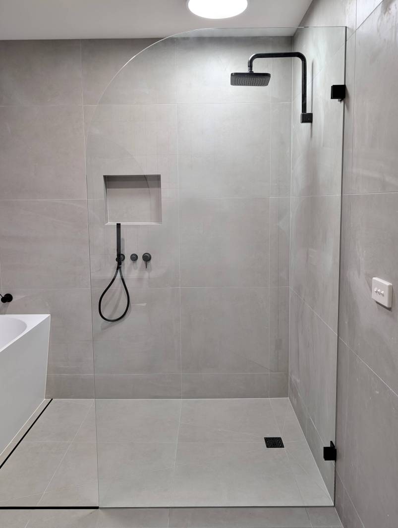 Curved Glass Shower Panels Melbourne Walk in shower with a round edge glass shower panel in a grey bathroom