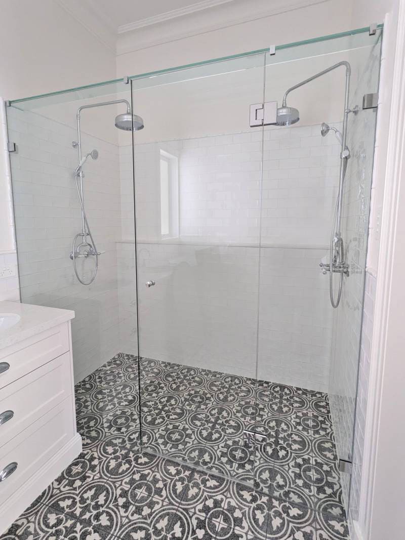 In-line frameless shower screen with chrome fittings in a Victorian style ensuite